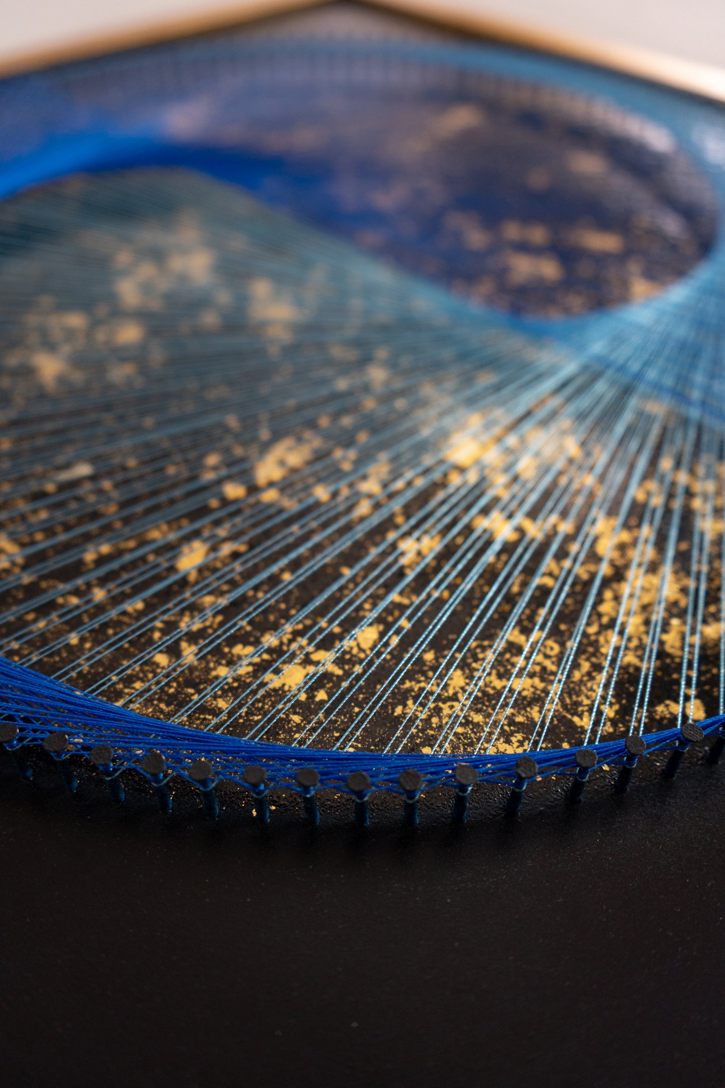 Close-up of Blue Galaxy Yin Yang – matte black texture, precise nails, strong thread, and radiant gold flakes in the heart of the symbol.
