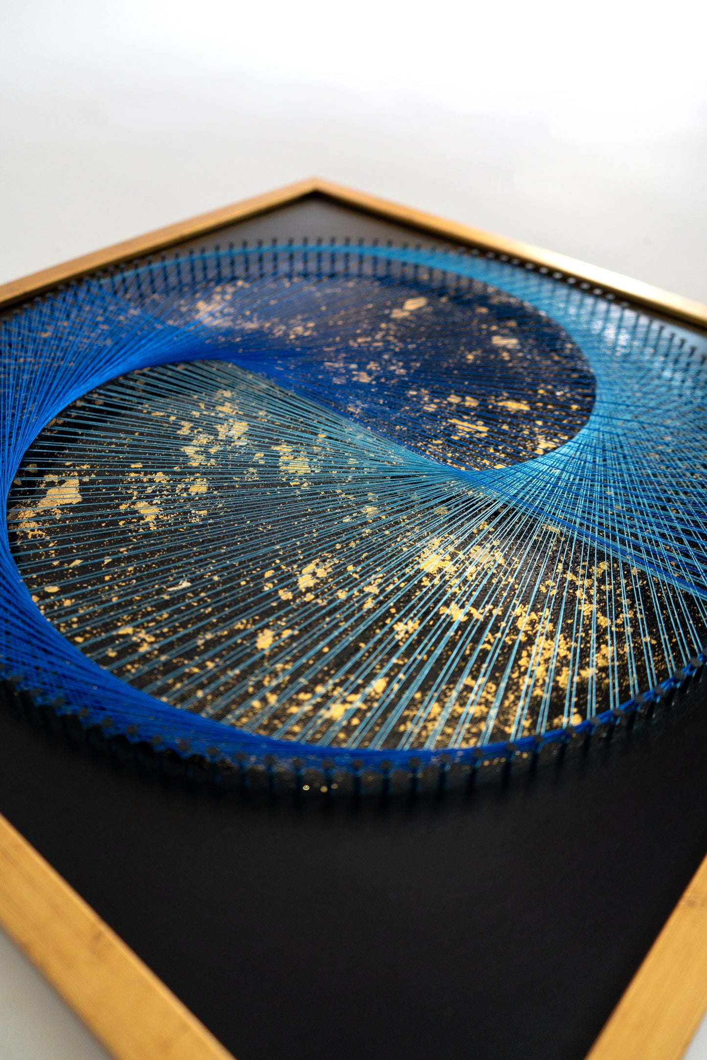 Left angle view of Blue Galaxy Yin Yang artwork – vibrant blue thread and sacred symbolism blending with golden harmony.
