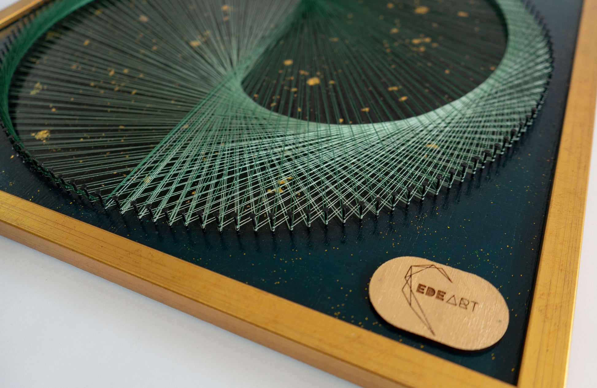 Close-up of EDEART logo on Green Galaxy Yin Yang string art with beautiful green thread, emphasizing the shimmering gold glitter background and branding.