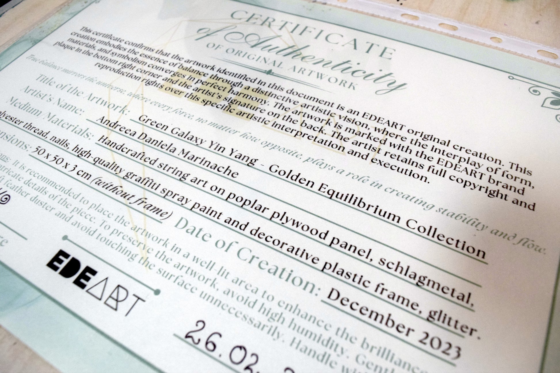 Green Galaxy Yin Yang artwork shown next to its Certificate of Authenticity, verifying original handmade EDEART concept.