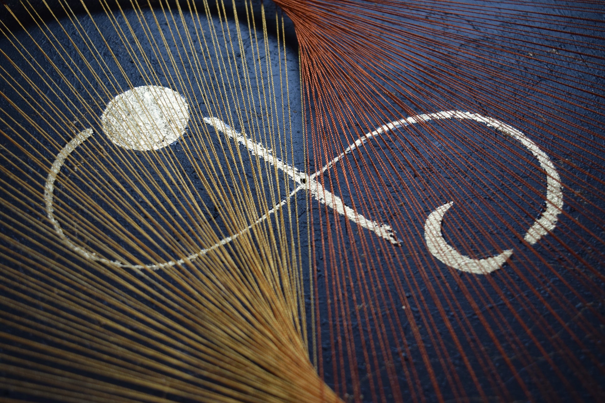 Macro shot of gold leaf infinity symbol with full and half moons – crafted with schlagmetal in spiritual symmetry.