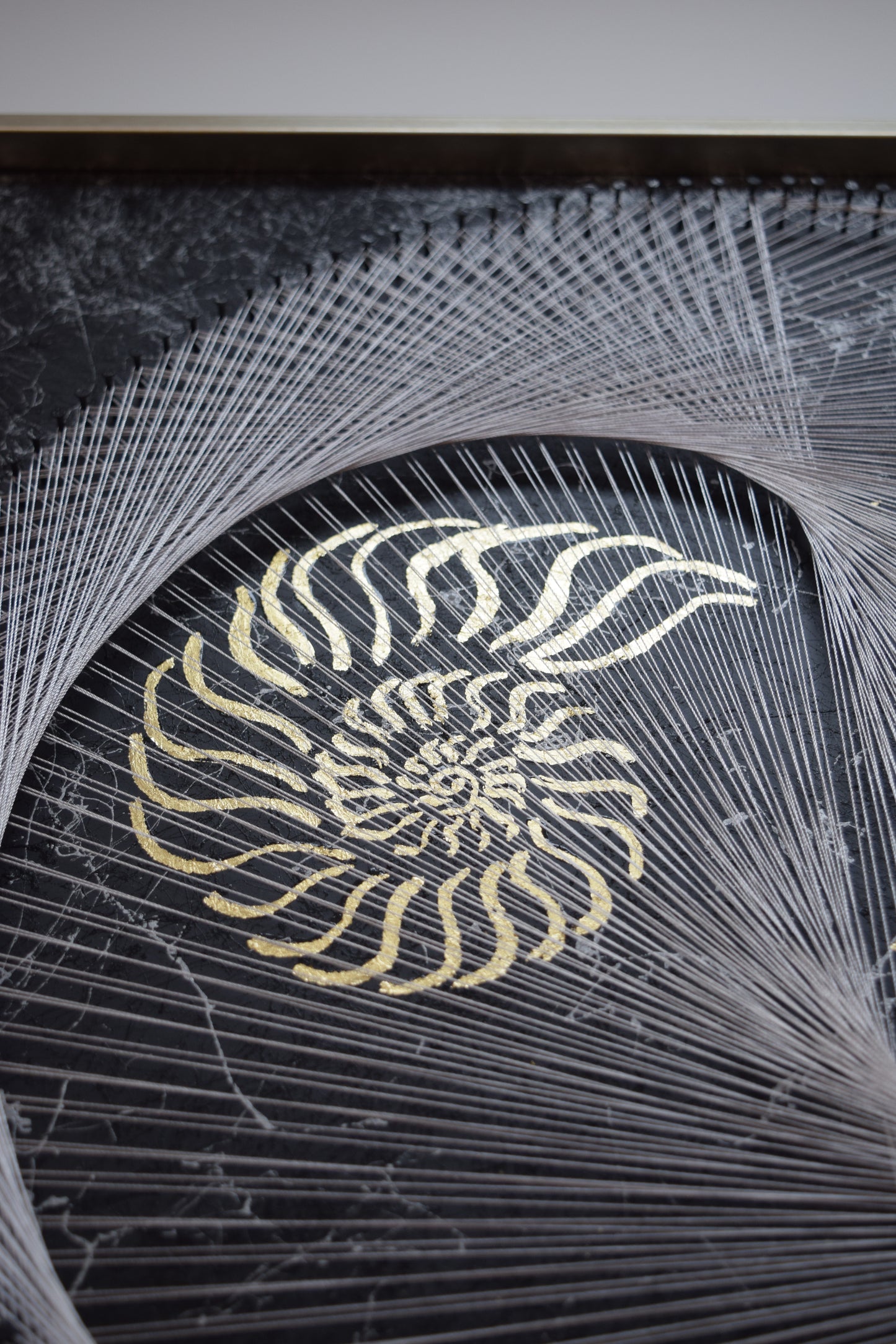 Zoom on the golden nautilus symbol in the artwork – representing nature’s sacred geometry and the golden spiral.