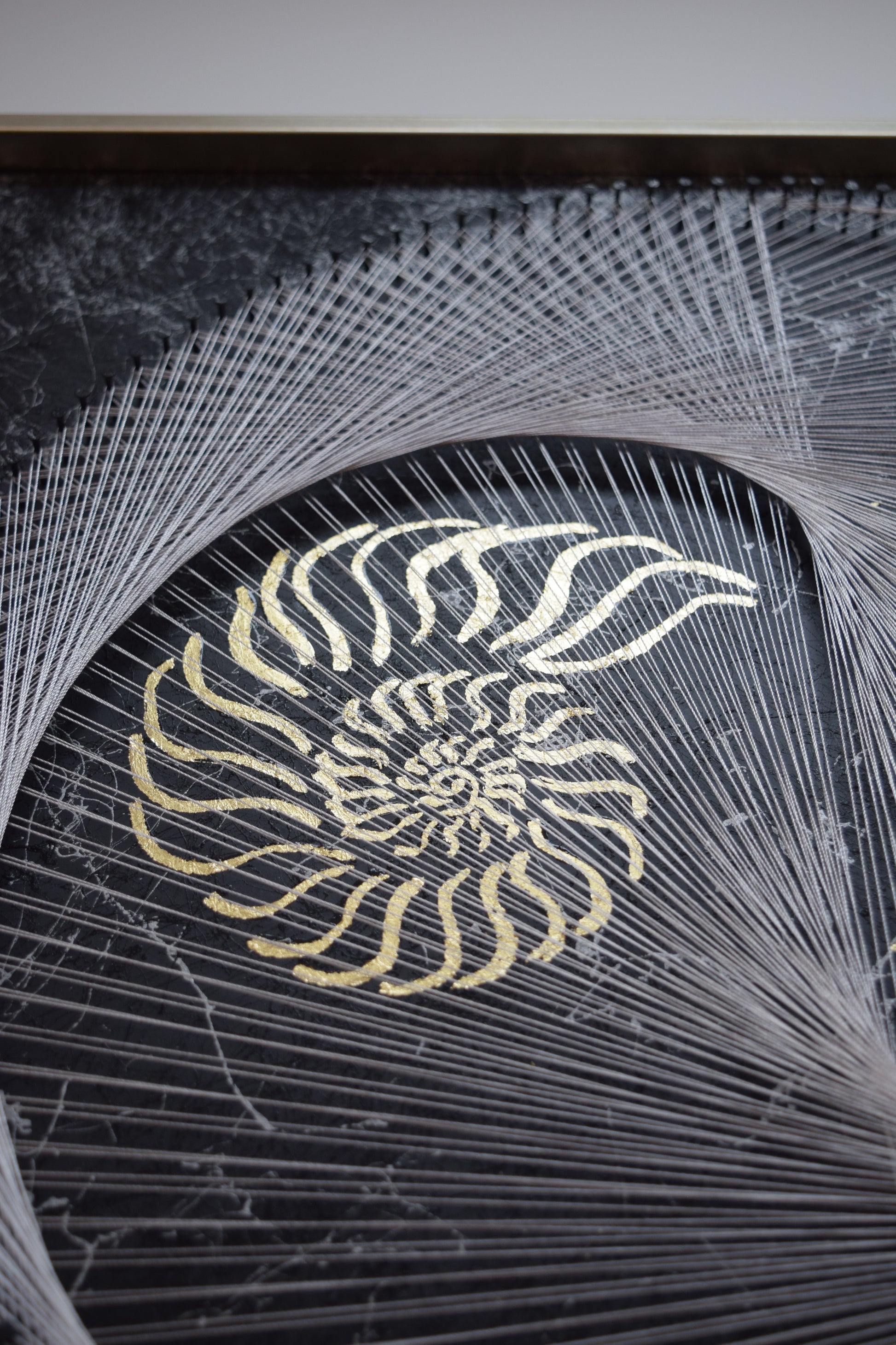 Zoom on the golden nautilus symbol in the artwork – representing nature’s sacred geometry and the golden spiral.