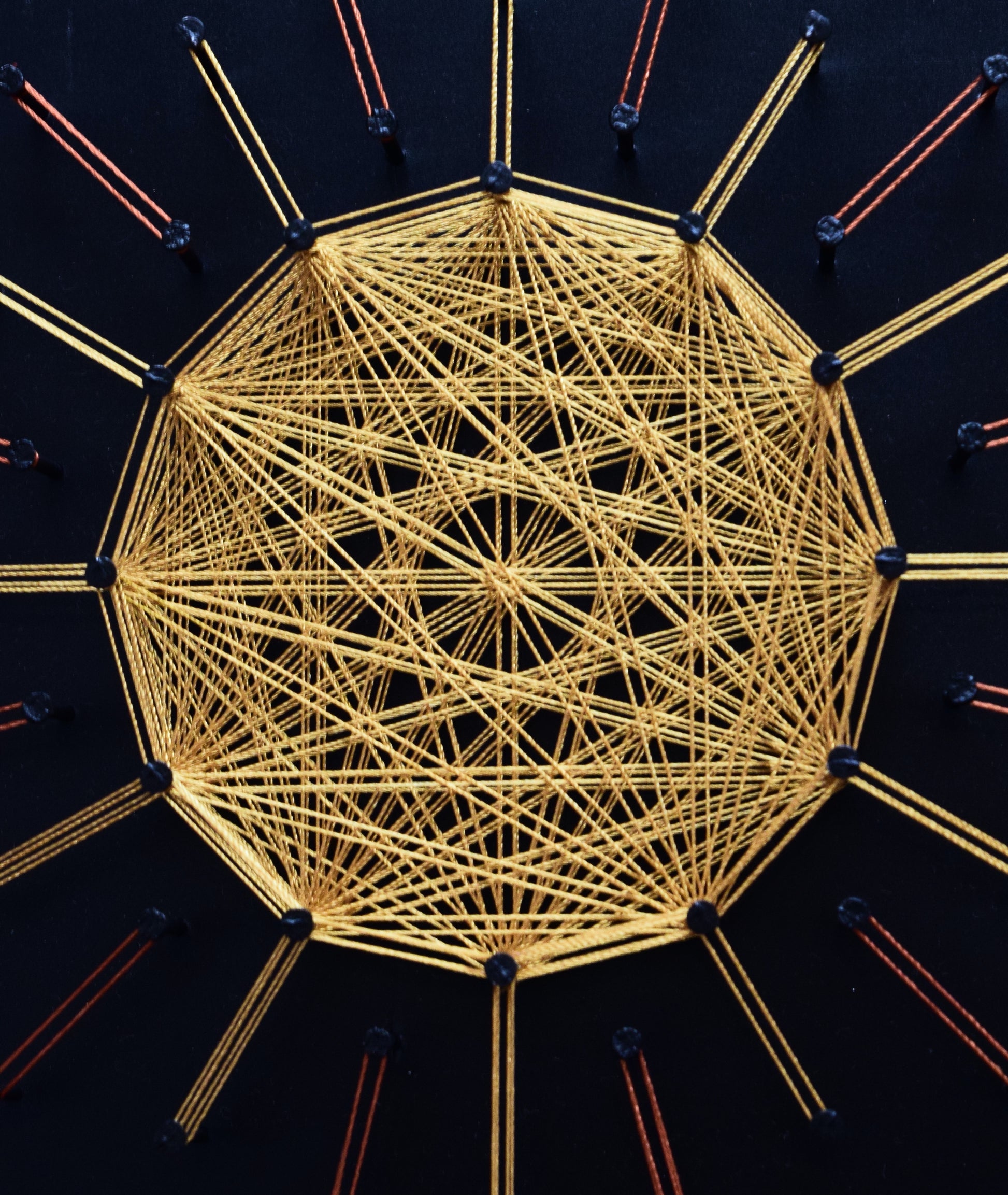 Close-up of gold string art sun mandala – spiritual and symbolic artwork