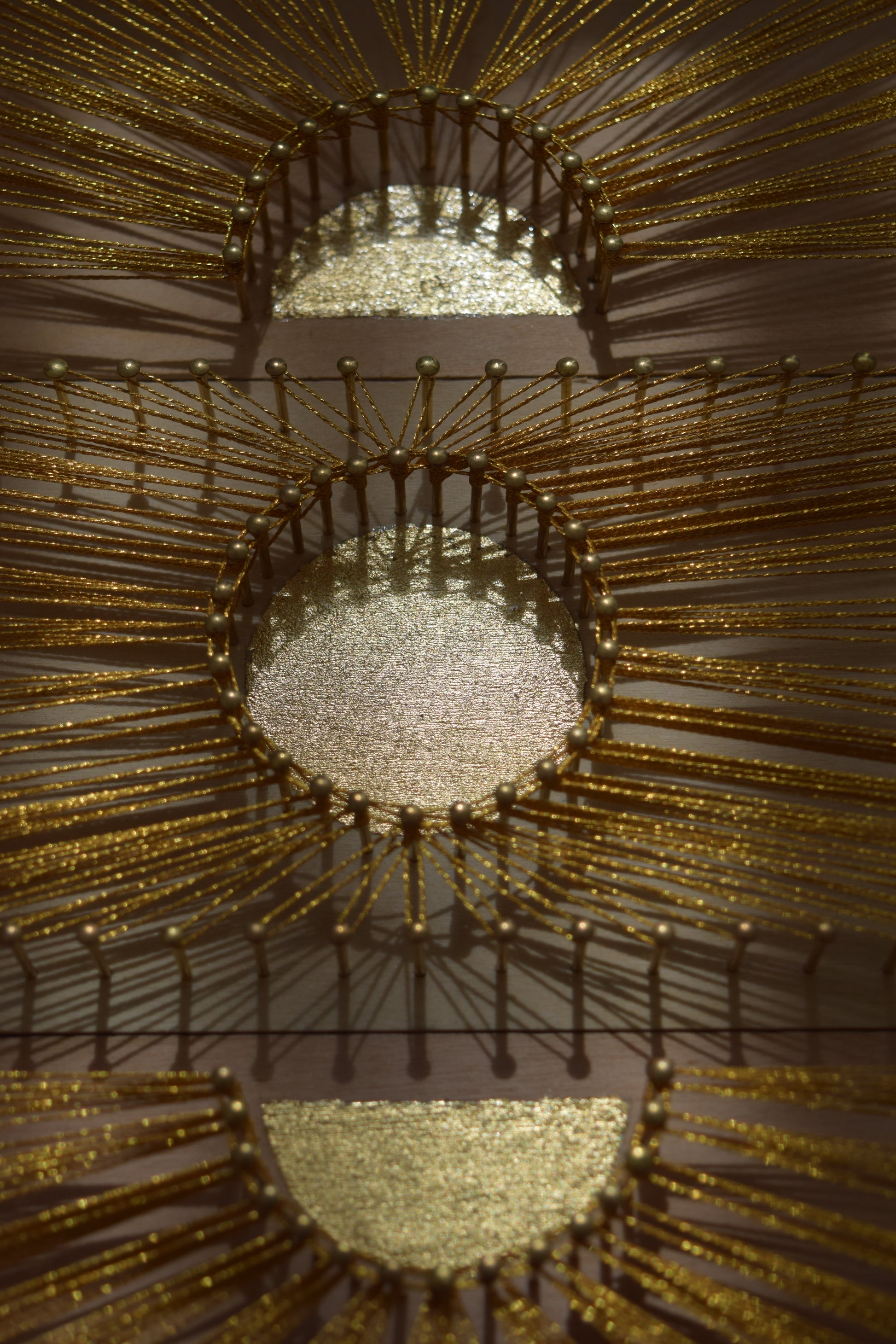 Close-up of the central gold leaf sun in Sun Phases artwork – radiant centerpiece reflecting warmth and light.