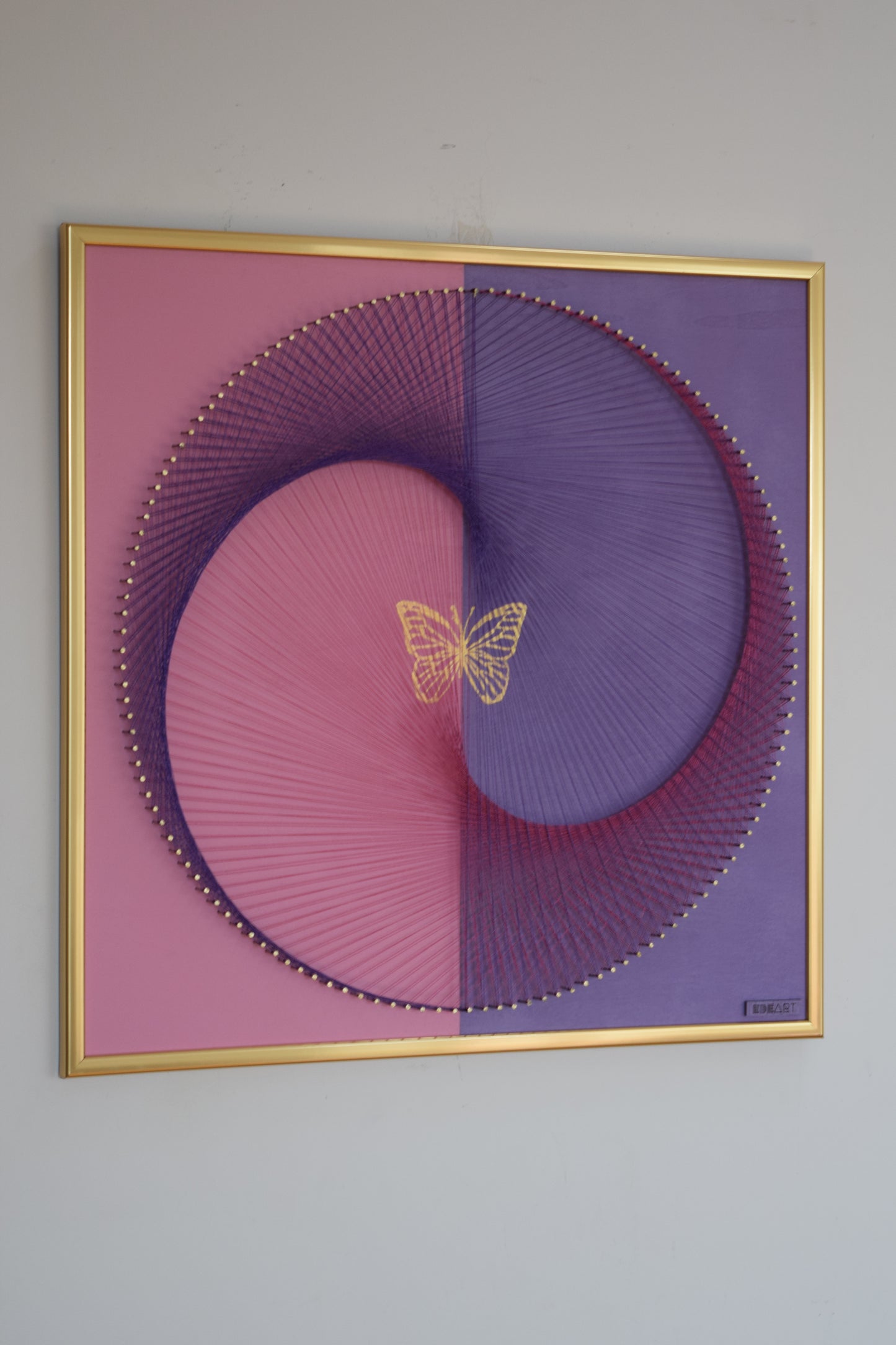 Contemporary symbolic artwork featuring butterfly and Yin Yang, created with thread and gold leaf. Spiritual and decorative piece for modern interiors.