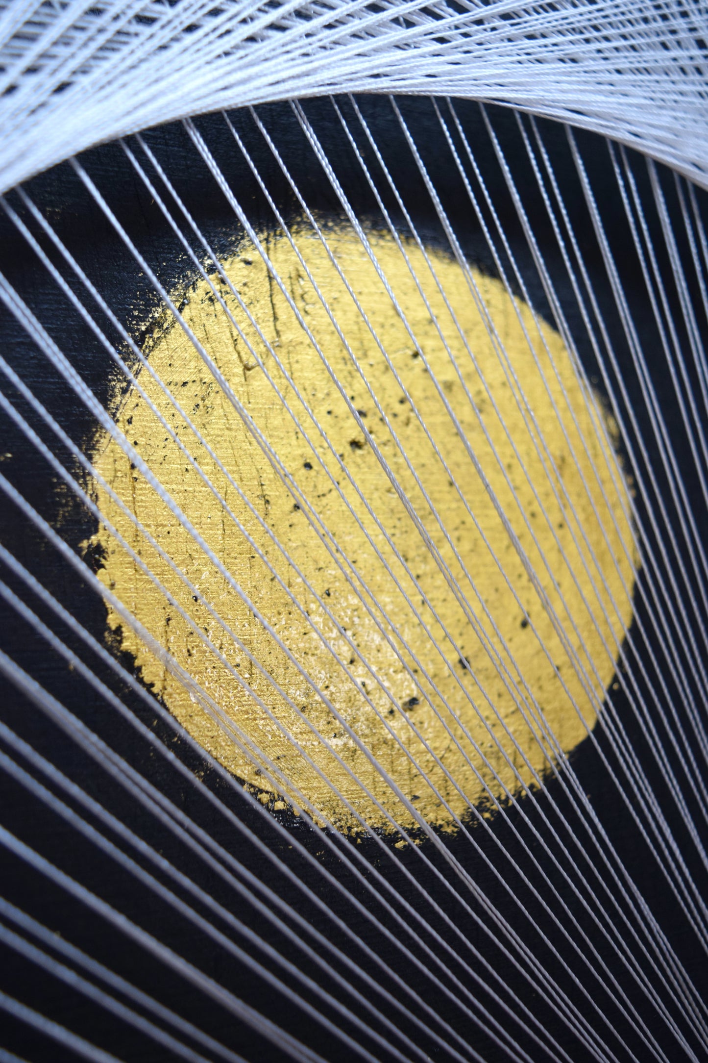 Macro shot of a 22K gold leaf full moon in White Yin Yang artwork – radiant texture and luxurious brilliance.