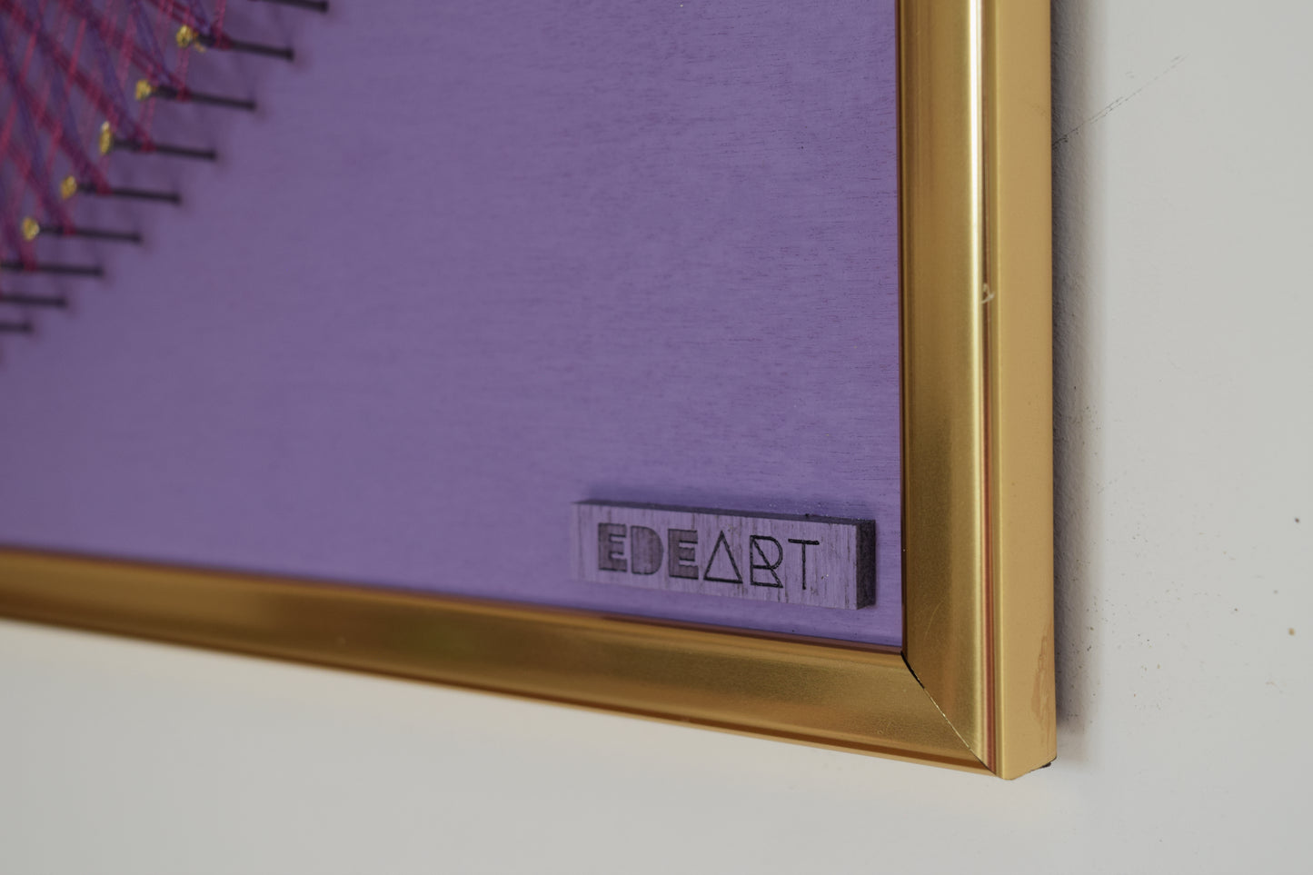 Close-up of EDEART logo on string art artwork, showcasing fine branding and artistic craftsmanship.