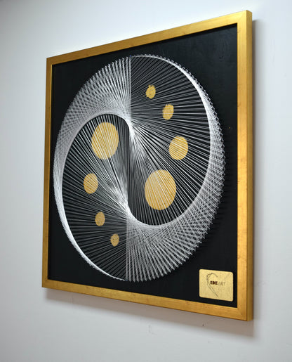 Right angle view of White Yin Yang painting with 22K gold full moons and elegant gold frame.