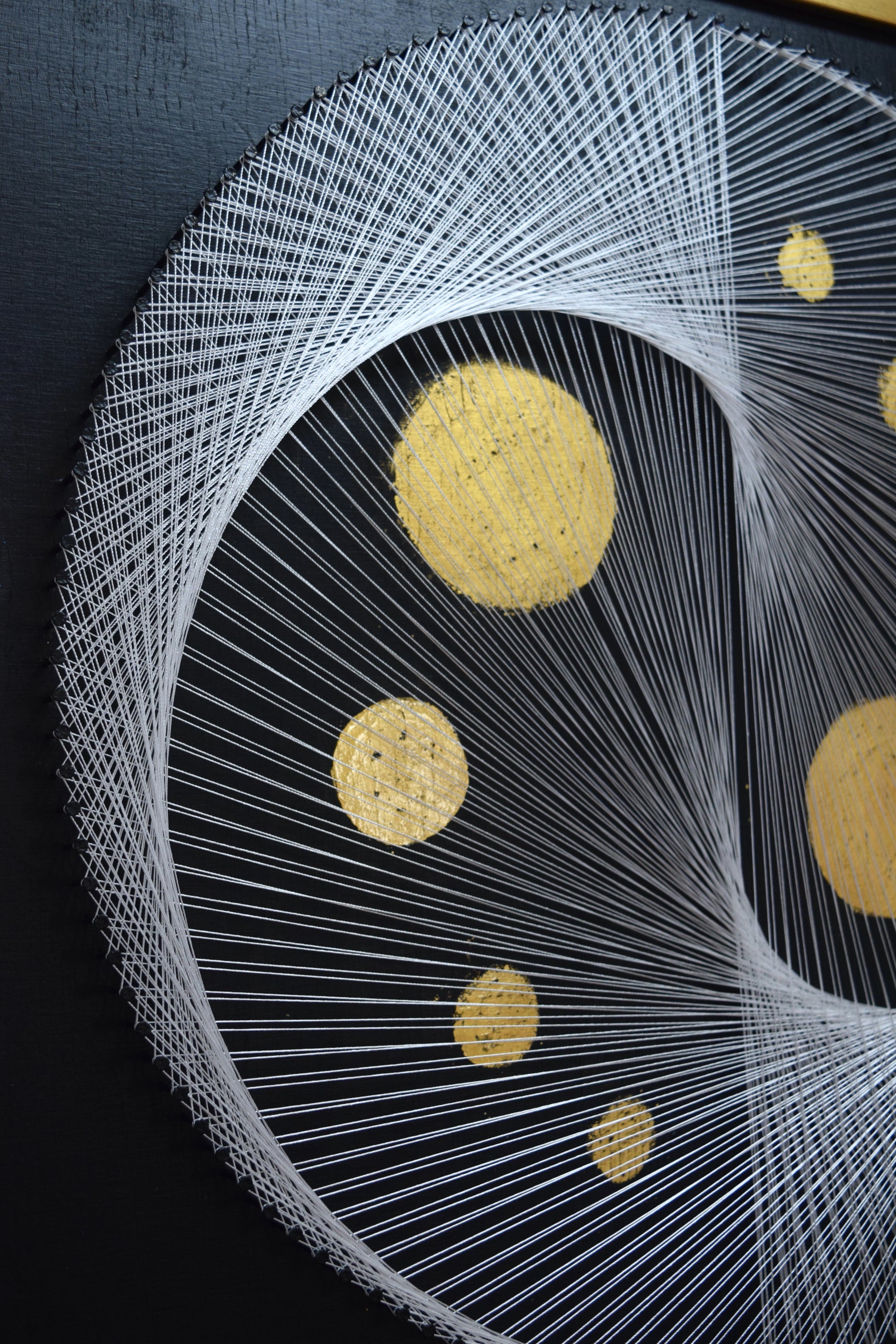 Close-up of thread structure in White Yin Yang artwork – detailed view of half the symbol, showing precision and texture.